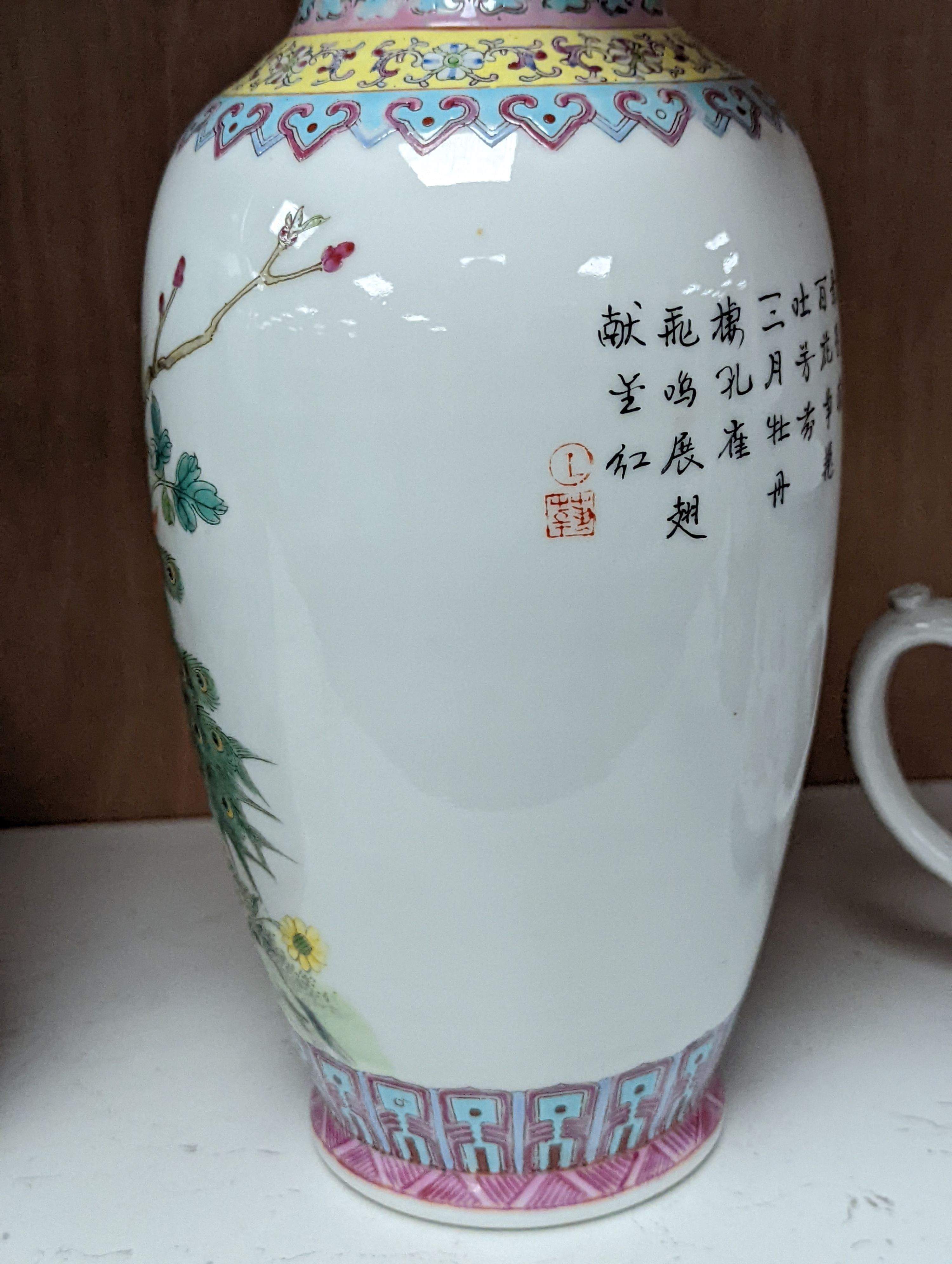 A pair of Chinese famille rose vases decorated with peacocks, 31cm